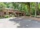 Two-story home with brick facade, wooden balconies, and lush landscaping at 4266 Roswell Ne Rd # L3, Atlanta, GA 30342