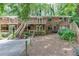 Brick home with wood balconies surrounded by trees and lush greenery at 4266 Roswell Ne Rd # L3, Atlanta, GA 30342