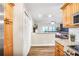 Bright, open kitchen featuring wooden cabinetry, stainless appliances, and a view into the living area at 4266 Roswell Ne Rd # L3, Atlanta, GA 30342