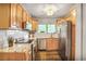 Well-lit kitchen with stainless steel appliances, wooden cabinets, granite countertops, and subway tile backsplash at 4266 Roswell Ne Rd # L3, Atlanta, GA 30342