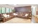 Spacious living room with a large leather sectional sofa, plush rug, and access to the entryway at 4266 Roswell Ne Rd # L3, Atlanta, GA 30342