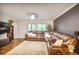 Cozy living room with a large leather sectional, plush carpet, and natural light from the adjacent windows at 4266 Roswell Ne Rd # L3, Atlanta, GA 30342