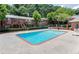 Large community swimming pool with lounge chairs, tables, and shade umbrellas, surrounded by apartments at 4266 Roswell Ne Rd # L3, Atlanta, GA 30342