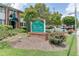 Community sign 'The Cove Condominium Homes' landscaped with greenery and brick border, close to entrance at 4266 Roswell Ne Rd # L3, Atlanta, GA 30342
