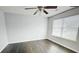 Bright bedroom featuring hardwood floors, ceiling fan, and large window, perfect for relaxation at 4397 Stone Gate Way, Atlanta, GA 30344
