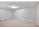 Unfinished basement featuring carpet and a drop ceiling at 232 Barrett Springs Way, Canton, GA 30115