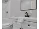 Bright bathroom featuring a shower and tub, white cabinets, matte black fixtures, and a modern sink at 232 Barrett Springs Way, Canton, GA 30115