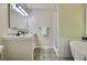 Modern bathroom featuring double vanity, bathtub, and separate tile shower with neutral color palette at 232 Barrett Springs Way, Canton, GA 30115