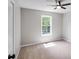Neutral bedroom featuring a ceiling fan and window, offering natural light at 232 Barrett Springs Way, Canton, GA 30115