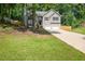 Charming home with a two-car garage, well-manicured lawn, and lovely landscaping provides great curb appeal at 232 Barrett Springs Way, Canton, GA 30115