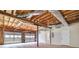 Spacious garage interior with exposed wood ceiling, two car capacity, shelving, and unfinished walls at 232 Barrett Springs Way, Canton, GA 30115