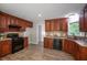 Well-equipped kitchen featuring stainless steel appliances, wood cabinets and wood-look floors at 232 Barrett Springs Way, Canton, GA 30115