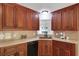 The kitchen features wood cabinets and granite countertops, offering both style and functionality at 232 Barrett Springs Way, Canton, GA 30115