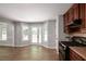 The kitchen features stainless steel appliances and leads to a breakfast nook filled with natural light at 232 Barrett Springs Way, Canton, GA 30115