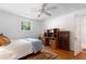 Cozy bedroom featuring hardwood floors, natural light, and a built-in desk with storage at 433 Pine Dr, Pine Lake, GA 30072