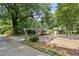 Home with screened-in porch, detached garage, and mature trees, set on a large lot with ample parking at 433 Pine Dr, Pine Lake, GA 30072