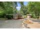 Home with a screened porch, detached garage, and mature trees, situated on a spacious lot, perfect for outdoor living at 433 Pine Dr, Pine Lake, GA 30072