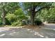 Street view of home with a screened porch, detached garage, and mature trees, offering curb appeal at 433 Pine Dr, Pine Lake, GA 30072