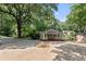 Home with a screened porch, detached garage, and mature trees, providing a private and peaceful setting at 433 Pine Dr, Pine Lake, GA 30072