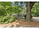Charming bungalow-style home with screened porch and mature trees in a lush, green setting at 433 Pine Dr, Pine Lake, GA 30072