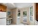 Bright kitchen area with white fridge, table, and door to outdoor space at 433 Pine Dr, Pine Lake, GA 30072