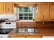 Charming kitchen sink with custom tile countertops and a view of the outside landscape at 433 Pine Dr, Pine Lake, GA 30072