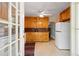 The kitchen features custom wood cabinets and tiled countertops, complemented by white appliances at 433 Pine Dr, Pine Lake, GA 30072