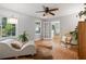 Bright and airy living room with hardwood floors, ceiling fan, and neutral decor at 433 Pine Dr, Pine Lake, GA 30072