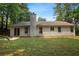 Well-maintained backyard featuring a lush green lawn and a charming exterior at 506 Bluff Ct, Woodstock, GA 30188