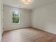 Well-lit bedroom with neutral walls, a large window, and wood-look floors, creating a welcoming atmosphere at 506 Bluff Ct, Woodstock, GA 30188