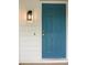 A bright blue front door with a modern black light fixture on a white-sided house at 506 Bluff Ct, Woodstock, GA 30188