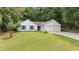 Inviting single-story home featuring a well-manicured lawn and an attached two-car garage at 506 Bluff Ct, Woodstock, GA 30188