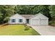 Charming single-Gathering home with a two-car garage, blue shutters, and mature landscaping at 506 Bluff Ct, Woodstock, GA 30188