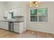 Kitchen sink with stainless steel dishwasher and a wooded view from the windows at 506 Bluff Ct, Woodstock, GA 30188