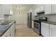 Clean kitchen with stainless steel appliances and updated fixtures at 506 Bluff Ct, Woodstock, GA 30188