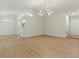 Spacious living room with hardwood floors, modern lighting, and an open floor plan at 506 Bluff Ct, Woodstock, GA 30188