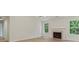Bright living room with a cozy fireplace, large windows with natural light, and modern flooring at 506 Bluff Ct, Woodstock, GA 30188