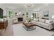 Bright living room with fireplace, wood floors, modern decor and large windows at 506 Bluff Ct, Woodstock, GA 30188
