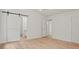 Primary suite with a barn door leading to the bathroom, offering privacy and style at 506 Bluff Ct, Woodstock, GA 30188