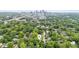 This property's aerial shot shows that it is surrounded by tree-lined neighborhood near the city skyline at 1001 Dunning Se St, Atlanta, GA 30315
