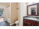 A view of the bathroom with a dark wood vanity, tile floors, and a shower/tub at 1001 Dunning Se St, Atlanta, GA 30315