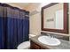 Bathroom featuring a single sink vanity, toilet, and shower with blue curtain at 1001 Dunning Se St, Atlanta, GA 30315