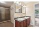Bathroom featuring double sink vanity, and walk-in shower with tile surround at 1001 Dunning Se St, Atlanta, GA 30315