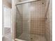 Bathroom showcasing a shower with sliding glass door and neutral tile at 1001 Dunning Se St, Atlanta, GA 30315