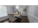 Elegant dining room featuring stylish chairs, modern art, a unique chandelier, and access to outdoor space at 1033 Hawk Creek Trl, Lawrenceville, GA 30043