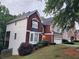 View of the side of the two-story home with brick and white siding and an attached garage at 1033 Hawk Creek Trl, Lawrenceville, GA 30043