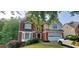 Charming two-story brick home with a well-manicured lawn and an attached two-car garage at 1033 Hawk Creek Trl, Lawrenceville, GA 30043