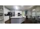 Open kitchen with white cabinets, an island, stainless appliances, and a connected dining area at 1033 Hawk Creek Trl, Lawrenceville, GA 30043