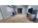Spacious living room featuring plush carpet, neutral color palette, and modern entertainment center at 1033 Hawk Creek Trl, Lawrenceville, GA 30043