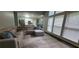 Spacious living room with large windows, modern furniture, and an open view into the bright kitchen at 1033 Hawk Creek Trl, Lawrenceville, GA 30043